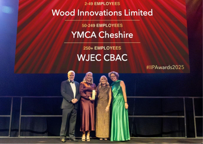 A group of people standing in front of a sign
AI-generated content may be incorrect.